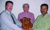 John Mentz of PLC Direct (left) presents the trophy to Roger Adriaanse. Keith Shaw (centre) is the SAIMC committee member who made it all happen